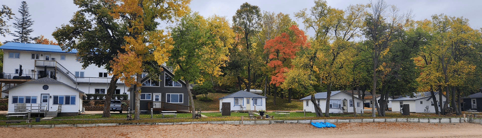 Shoreline of Heavenly Escapes lodge, cabins, with trees turning fall colors